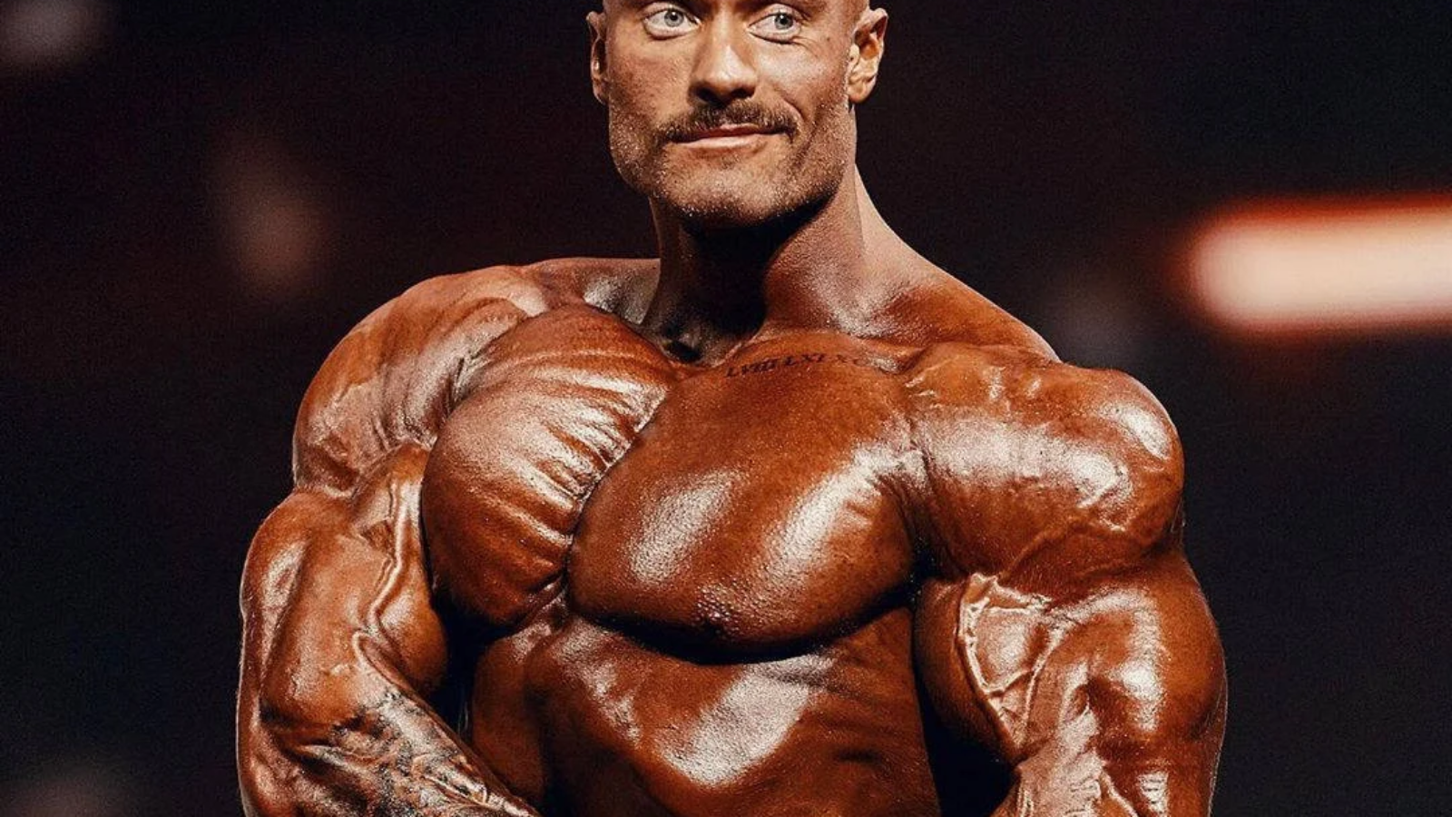 tanned-chris-bumstead-side-chest.webp